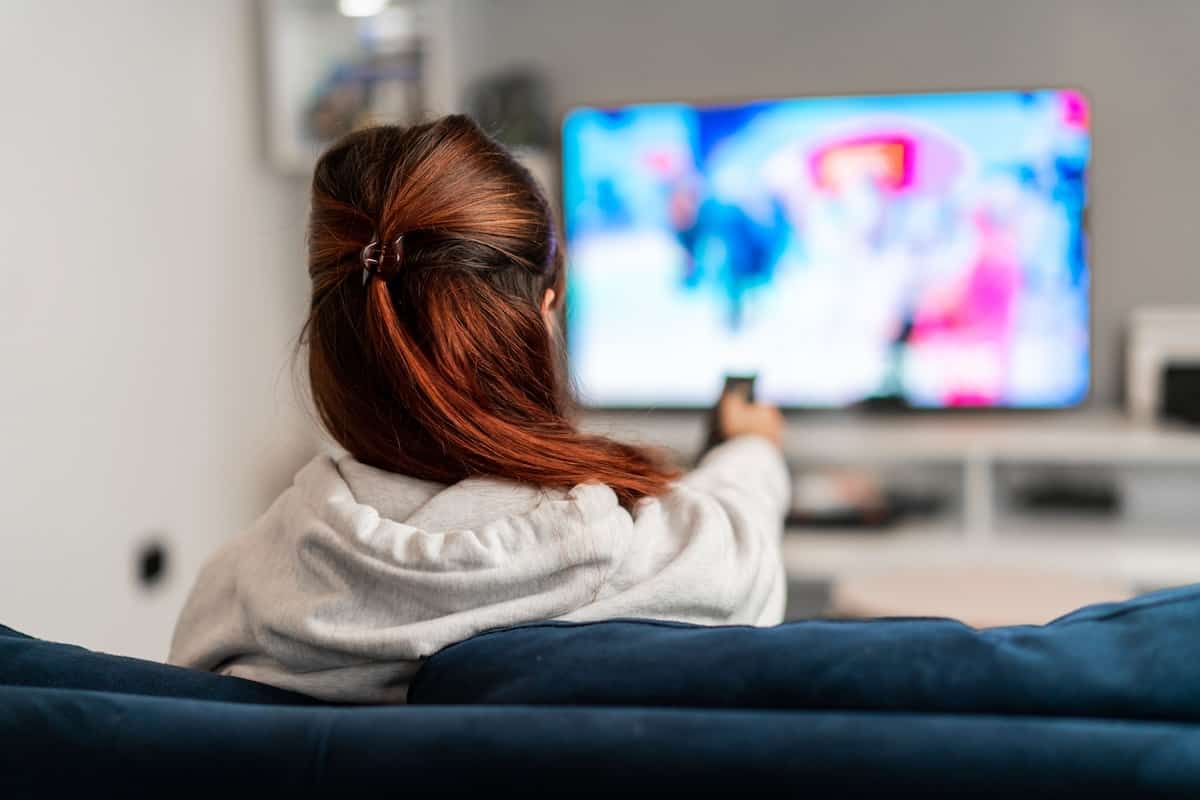 woman watching tv programs on the sofa